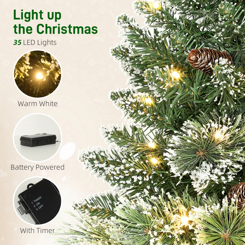 HOMCOM 60 cm Prelit Small Christmas Tree, Snow Flocked Tabletop Mini Xmas Tree with 35 LED Lights, Pine Cones and Linen Cover Base, Battery Operated, Green