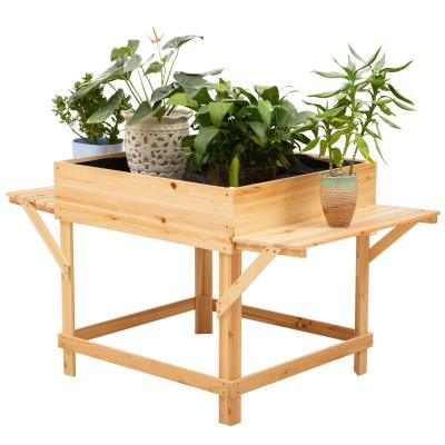 Verhoogd bed gemaakt van hout plantenbak voor de tuin met aflegvlak bloembed naturel